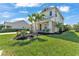 Well-manicured lawn and landscaping frame this home's exterior with a covered porch and a two-car garage at 7048 White Willow Ct, Sarasota, FL 34243