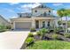 Charming two-story home with a well-manicured lawn and inviting front porch at 7048 White Willow Ct, Sarasota, FL 34243