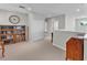 Hallway with neutral colors, hard wood furniture, and a decorative clock and shelving at 7048 White Willow Ct, Sarasota, FL 34243