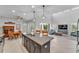 Open-concept kitchen with island, seamlessly connected to the living and dining areas at 7048 White Willow Ct, Sarasota, FL 34243