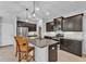 Modern kitchen with granite countertops, stainless steel appliances, and a center island at 7048 White Willow Ct, Sarasota, FL 34243