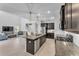 Open-concept kitchen with island, seamlessly connected to the living and dining areas at 7048 White Willow Ct, Sarasota, FL 34243