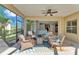 Cozy screened lanai with wicker furniture and ceiling fan, offers a comfortable outdoor living space at 7048 White Willow Ct, Sarasota, FL 34243