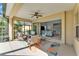 Screened lanai features a ceiling fan and wicker furniture, perfect for outdoor relaxation and entertaining at 7048 White Willow Ct, Sarasota, FL 34243