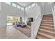 Bright living room featuring soaring ceilings, neutral tones, and an open floor plan at 7048 White Willow Ct, Sarasota, FL 34243