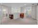 Upstairs loft featuring decorative furniture, neutral carpet and paint, and plenty of natural light at 7048 White Willow Ct, Sarasota, FL 34243
