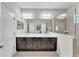 Bathroom with dual sinks, a shower and a large mirror at 7048 White Willow Ct, Sarasota, FL 34243