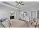 Bright main bedroom boasts a tray ceiling and ensuite bathroom entrance at 7048 White Willow Ct, Sarasota, FL 34243