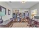 Bright office with built-in bookshelves, desk and chair, and neutral color scheme at 7048 White Willow Ct, Sarasota, FL 34243