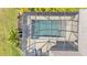 Aerial view of a screened-in pool and patio with landscaping at 7048 White Willow Ct, Sarasota, FL 34243