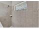 Tiled shower with handheld shower head and a window at 7048 White Willow Ct, Sarasota, FL 34243