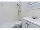 Bright bathroom features a shower-tub combo with white tile surround, a toilet, and vanity sink at 8055 112Th St # 306, Seminole, FL 33772