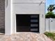 Modern garage door featuring sleek horizontal windows, complementing the home's contemporary exterior at 820 Bay Point Dr, Madeira Beach, FL 33708