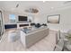 Bright living room with white couches, a ceiling fan, a fireplace, and access to outside at 820 Bay Point Dr, Madeira Beach, FL 33708