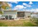 Charming backyard featuring a chicken coop, patio with chairs, and a screened-in porch at 901 W Plymouth St, Tampa, FL 33603