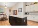 Charming kitchen island with granite countertops and dark wood cabinets adjacent to breakfast table at 901 W Plymouth St, Tampa, FL 33603