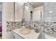 Bathroom featuring river rock accents, white brick style tile, and modern fixtures at 1000 Michigan Blvd, Dunedin, FL 34698