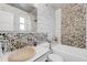 Bathroom featuring river rock accents, tile shower and flooring, and modern fixtures at 1000 Michigan Blvd, Dunedin, FL 34698