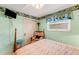 Bedroom featuring decorative wallpaper border, window with blinds, chair, and closet at 1000 Michigan Blvd, Dunedin, FL 34698