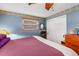 Bedroom featuring decorative wallpaper border, window with blinds, and closet at 1000 Michigan Blvd, Dunedin, FL 34698