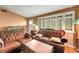 Spacious living room featuring leather sofas, neutral walls, and lots of natural light at 1000 Michigan Blvd, Dunedin, FL 34698
