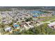 Aerial view of a residential neighborhood featuring one-story homes, well-maintained yards, and a nearby lake at 1112 21St E St, Palmetto, FL 34221