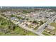 Panoramic aerial view of a residential neighborhood featuring various one-story homes, manicured lawns, and mature trees at 1112 21St E St, Palmetto, FL 34221