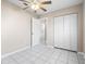 Bedroom featuring tile floors, a ceiling fan and a closet with white doors at 1112 21St E St, Palmetto, FL 34221