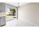 Bright dining area featuring white tiled floor, modern light fixture, and sliding glass doors to the backyard at 1112 21St E St, Palmetto, FL 34221