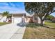 Inviting single-Gathering home featuring lush landscaping, mature trees, and a convenient one-car garage at 1112 21St E St, Palmetto, FL 34221