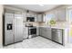 Updated kitchen showcases stainless steel appliances, gray cabinets, and sleek white countertops for modern appeal at 1112 21St E St, Palmetto, FL 34221