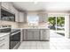 Updated kitchen featuring stainless steel appliances, gray cabinets, and tile flooring at 1112 21St E St, Palmetto, FL 34221