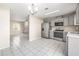 Modern kitchen area boasts stainless steel appliances, gray cabinetry, and seamless flow into the living space at 1112 21St E St, Palmetto, FL 34221
