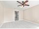 Neutral living room featuring tile floors, ceiling fan, and an open doorway at 1112 21St E St, Palmetto, FL 34221