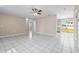 Expansive open living area with white tiled floors flowing towards the kitchen and backyard access at 1112 21St E St, Palmetto, FL 34221