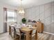 Inviting dining room with modern decor, featuring a wooden table, comfortable chairs, and decorative wall paneling at 2432 White Ladyfish Rd, Wimauma, FL 33598