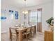 Cozy dining area featuring a wooden table, comfortable chairs, and a stylish chandelier at 2432 White Ladyfish Rd, Wimauma, FL 33598
