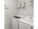 Efficient laundry room includes a Samsung washer and dryer, plus shelving for storage at 2432 White Ladyfish Rd, Wimauma, FL 33598