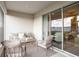 Covered patio with comfortable seating, a neutral rug, and sliding glass doors to the interior at 2432 White Ladyfish Rd, Wimauma, FL 33598