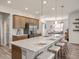 Open kitchen featuring an island with seating and modern lighting at 2432 White Ladyfish Rd, Wimauma, FL 33598