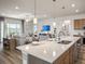 Open-concept living space with a kitchen island and plenty of natural light at 2432 White Ladyfish Rd, Wimauma, FL 33598