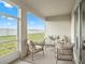Covered patio with outdoor seating area and views of the backyard and blue sky at 2432 White Ladyfish Rd, Wimauma, FL 33598