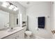 Bright bathroom featuring a tub with shower, toilet and a white vanity with countertop at 2909 Sutton Oaks Ct, Plant City, FL 33566