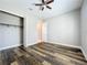 Bedroom featuring wood floors, closet, ceiling fan, and access to the rest of the house at 2932 Sky Blue Cv, Bradenton, FL 34211