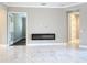 Living room features marble floors, and a modern fireplace at 2932 Sky Blue Cv, Bradenton, FL 34211