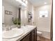 Well-lit bathroom featuring double vanity, framed mirror, and tub with shower at 6022 Mangrove Creek Rd, Wimauma, FL 33598