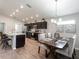 Open concept kitchen with stainless appliances, island seating, adjacent to dining area at 6022 Mangrove Creek Rd, Wimauma, FL 33598