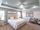 Spacious main bedroom with elegant décor, tray ceiling, and cozy sitting area at 6022 Mangrove Creek Rd, Wimauma, FL 33598