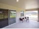 Covered patio with comfortable seating overlooking a scenic pond at 6022 Mangrove Creek Rd, Wimauma, FL 33598