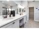 Elegant bathroom with dual sinks, vanity area, and a well-lit mirror at 6062 Barracuda Loop, Wimauma, FL 33598